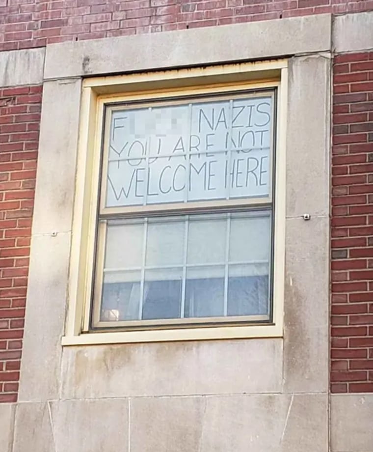 Image: Nicole Parsons hung a sign that read "F--- Nazis You Are Not Welcome Here" in her dorm room window at the University of Massachusetts campus in Amherst.
