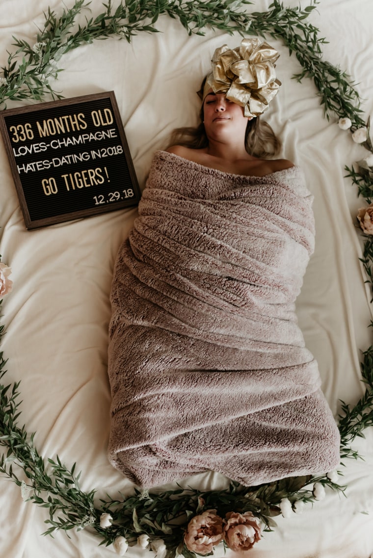 Woman poses in swaddle for funny birthday photo