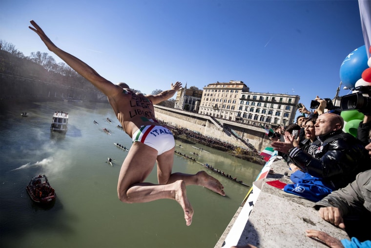 Image: Simone Carabella jumps from the Cavour Bridge into the Tiber River in Rome, Italy. The bridge is 49 feet high.