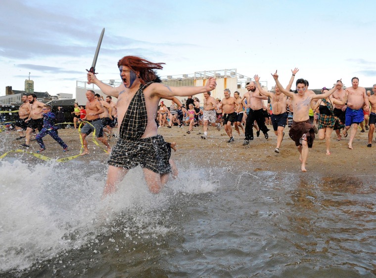 Image: \"Polar Bear\" swimmers take part in the L Street Brownies New Year's Day Plunge in South Boston, Massachusetts.