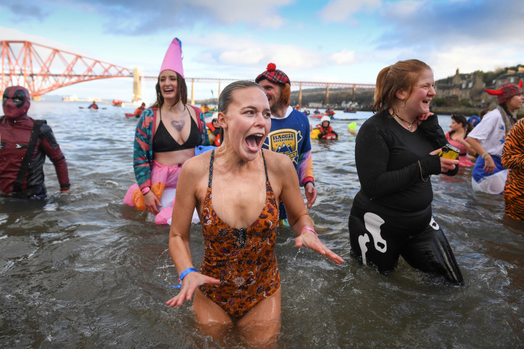 Image: Swimmers take the plunge in the Loony Dook Swim in the River Forth near Edinburgh, Scotland.
