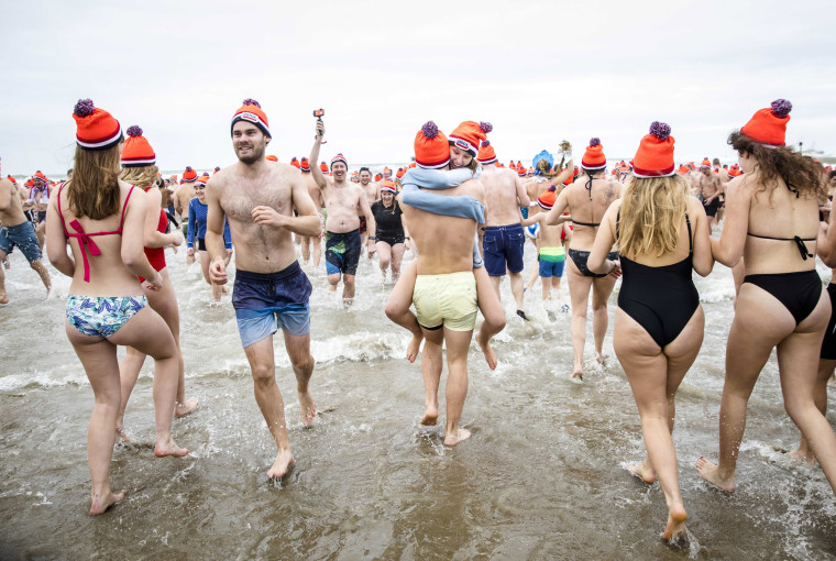 Image: Revelers hug at the plunge in the North Sea in Scheveningen, The Netherlands.