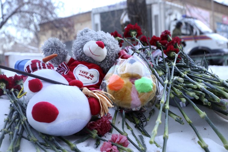Image: Toys and flowers left at the scene in Magnitogorsk, Russia.
