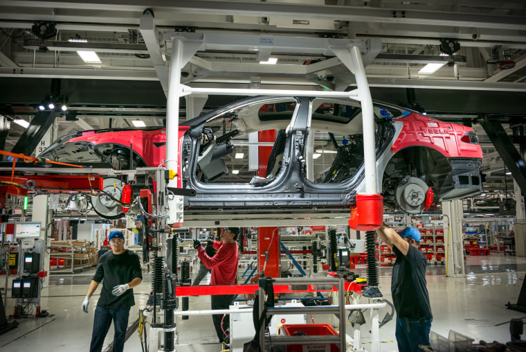 Image: Workers assemble cars on the line at a Tesla factory in Fremont, California, on Feb. 4, 2015.