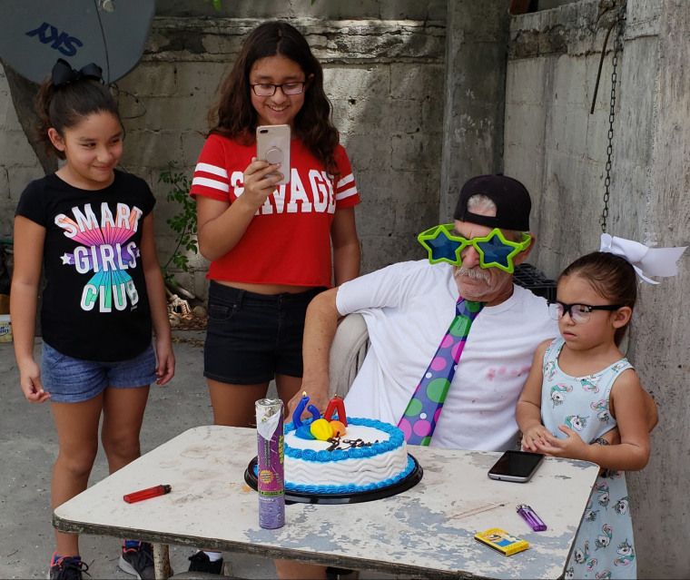 Image: Carlos Torres is surrounded by his grandchildren at his birthday celebration on Aug. 12, 2018.