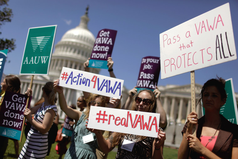 Image: Demonstrators hold a rally in support of the Violence Against Women Act on Capitol Hill on June 26, 2012.