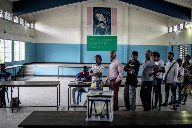 Image: Voters wait to cast their ballots at a school in Kinshasa 