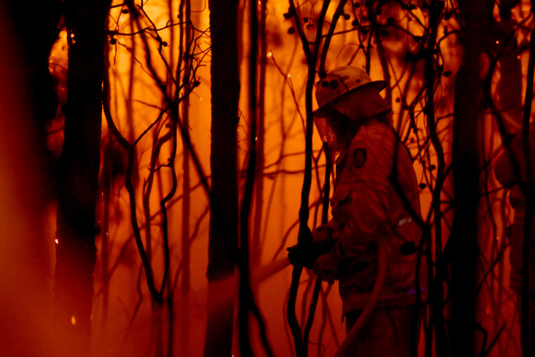 Image: A firefighter battles a bush fire near the town of Sussex Inlet on Dec. 31, 2019.
