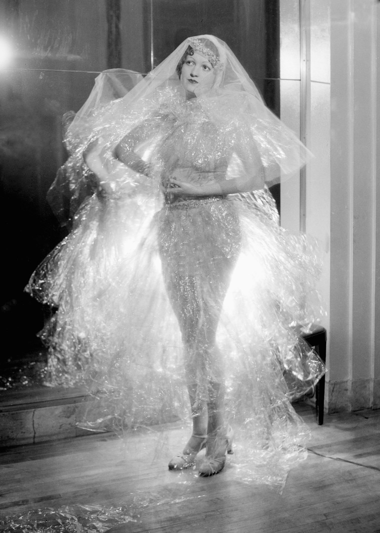 Woman models a plastic see-through dress, ca. 1942