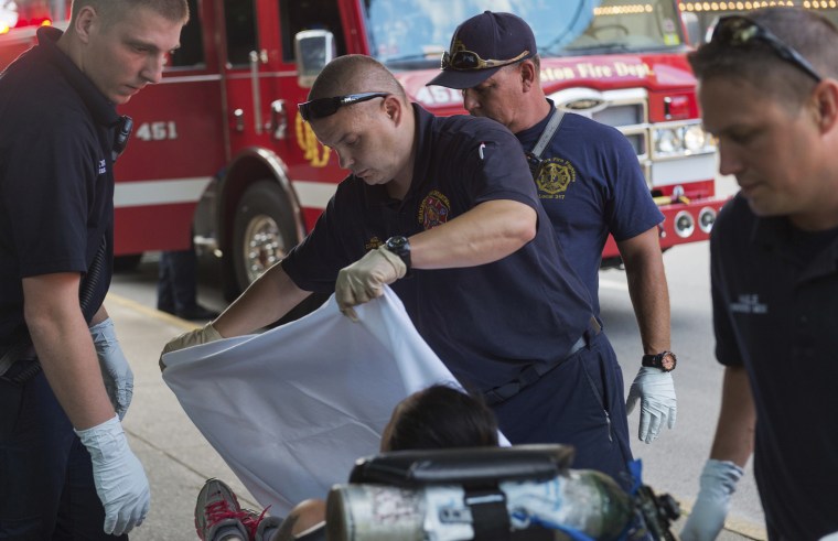 Emergency responders tend to a woman believed to be overdosing on methamphetamine in Charleston, West Virginia, in July.