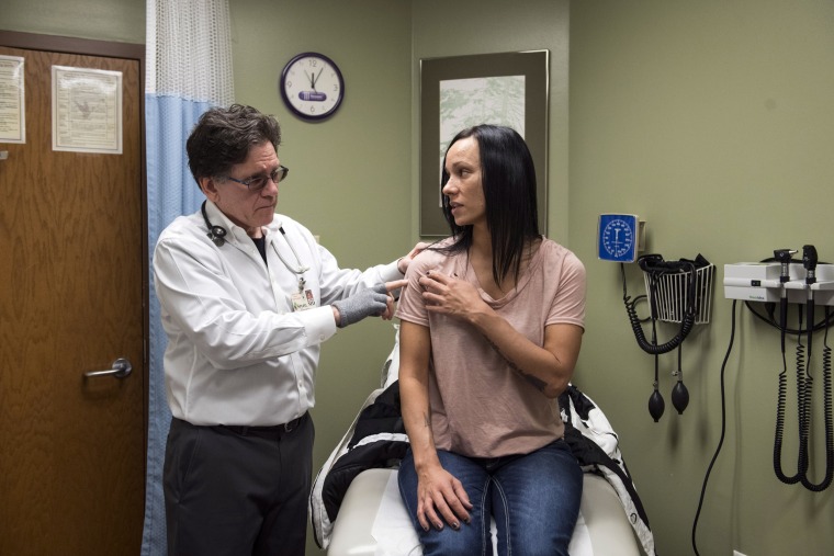 Image: Dr. Lowell Styler treats Ashley Gravelle for a shoulder injury at the Sault Tribe Health and Human Services in Sault Ste. Marie, Michigan, on Dec. 31, 2018.