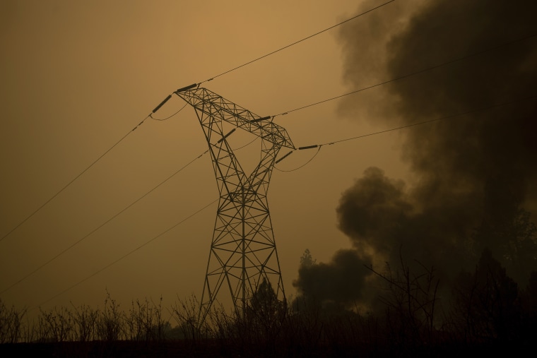 Image: Smoke billows around power transmission lines as the Camp Fire burns in Big Bend, California, on Nov. 9, 2018.