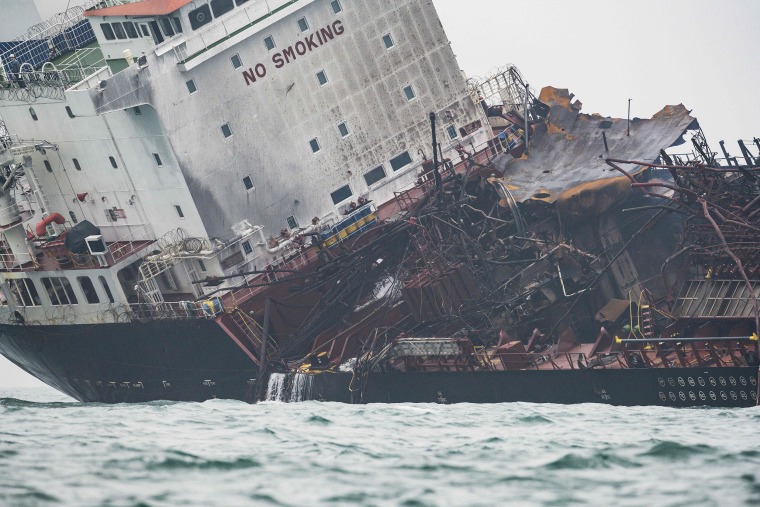 Image: The damaged oil tanker tilts to one side off Hong Kong's southern coast