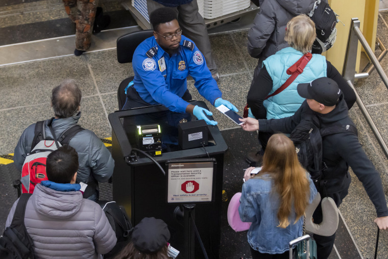 Image: A TSA agent checks identification at Ronald Reagan Washington National Airport on Jan. 7