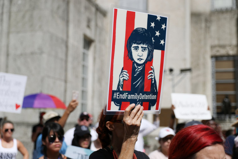 Demonstrators protest the Trump administration's immigration policies during a "Families Belong Together" rally in Houston