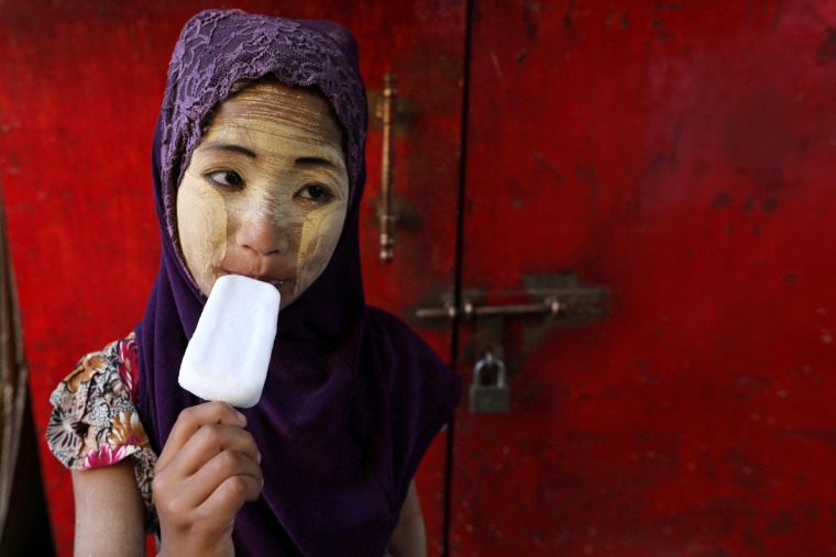 Image: Girl eats a popsicle during Myanmar's 71st Independence Day in Yangon