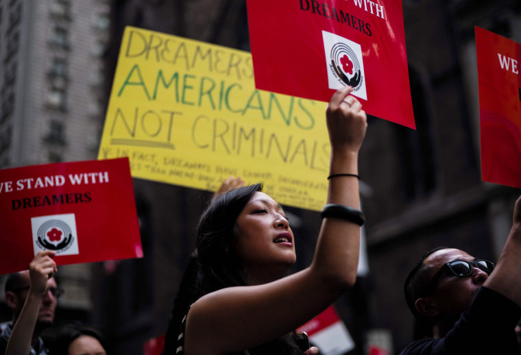 Image: Protesters hold up signs supporting DACA