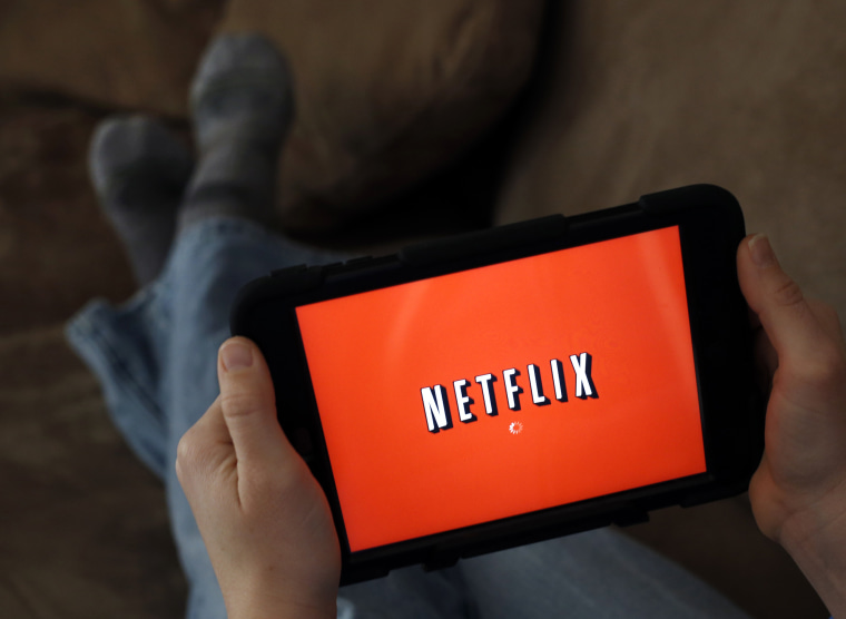 Image: A person displays Netflix on a tablet