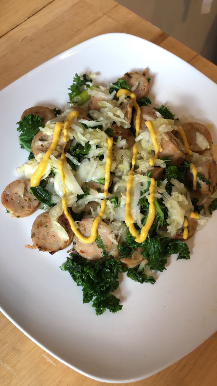 One of Page's favorite Whole30 meals: Trader Joe's Spicy Italian Chicken Sausage sauteed with kale, onions and olive oil, topped with mustard and sauerkraut.