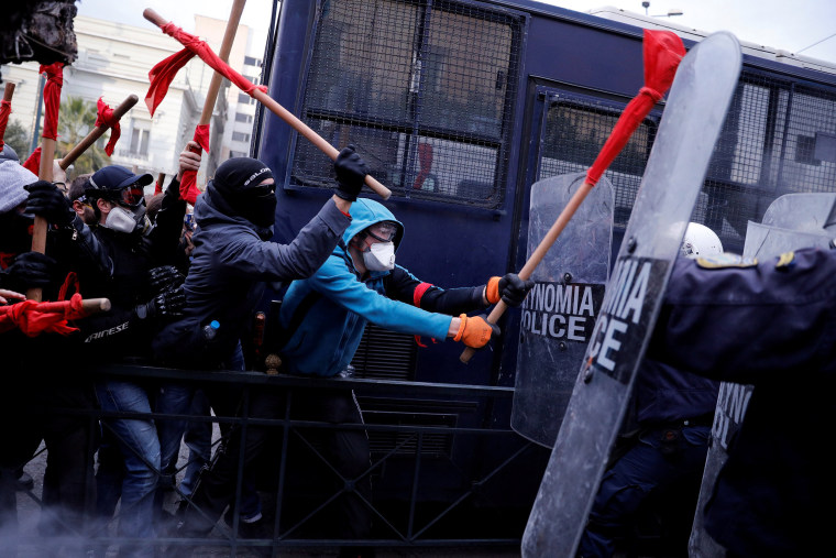 Image: Protesters clash with riot police during a demonstration of Greek school teachers outside the parliament building against government plans to change hiring procedures in the public sector in Athens