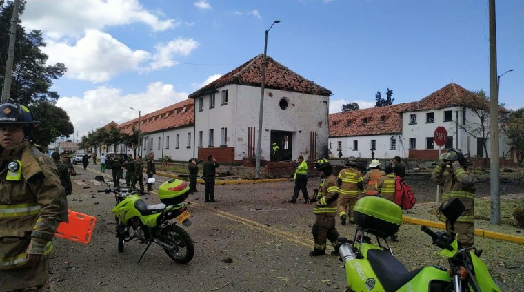 Emergency personnel respond to the scene of a deadly car bombing at a police academy