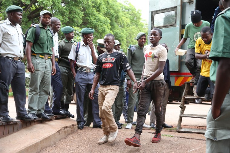 Image: Protesters are brought to a court in Harare, Zimbabwe