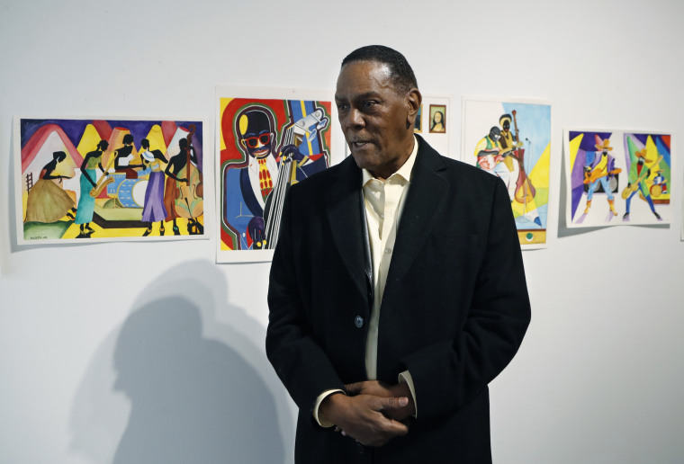 Richard Phillips stands next to some of his artwork during an interview at the Community Art Gallery in Ferndale, Michigan, on Jan. 17, 2019.