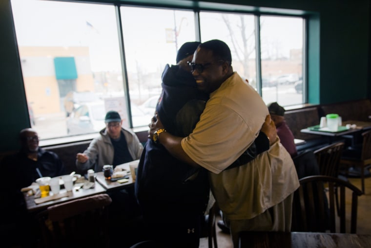 Image: Edward Douglas hugs his longtime friend, Art Lewis