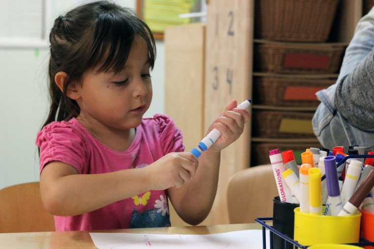 A student at a Kidango child care center in San Jose colors during play time.