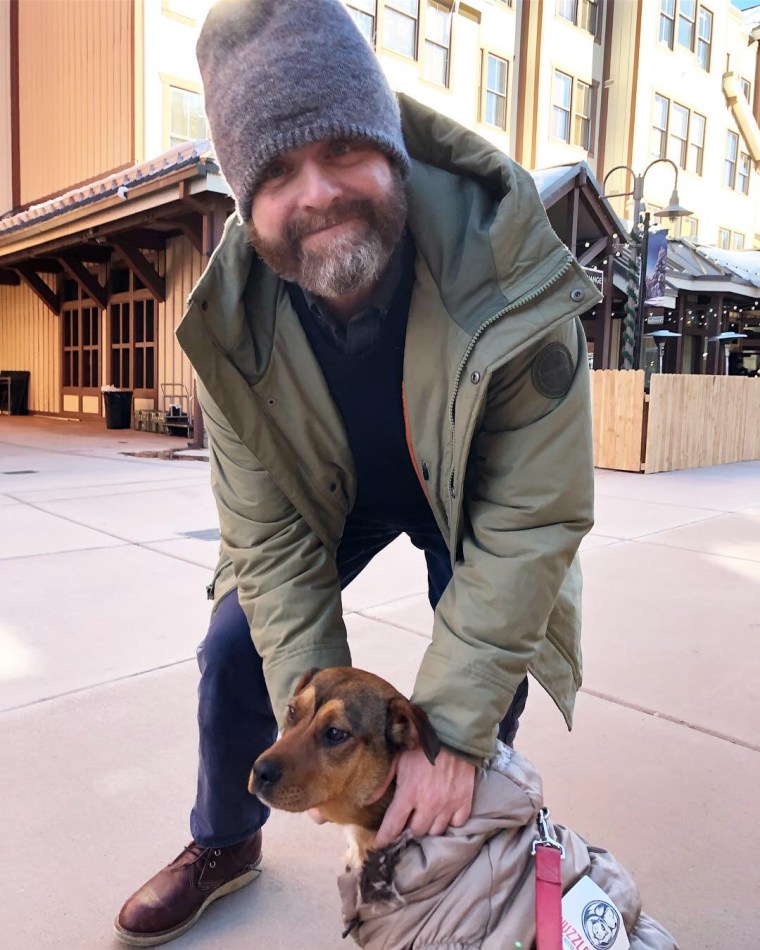 Zach Galifianakis stops to pet Thing 1, a rescue dog available for adoption at Nuzzles &amp; Co.