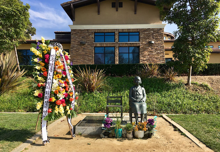 Flowers adorn a statue in in Glendale, California to commemorate Bok-dong Kim, a prominent comfort woman who died Monday. Kim visited Glendale in 2012 and 2013 and helped build the monument.