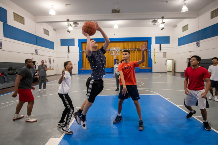 Kids play basketball after school in the gym at the Hazleton Integration Project