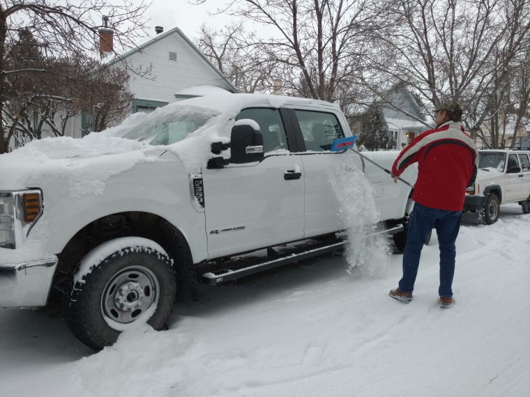 Mel Jackson cleaning snow off of his F-150 pickup truck with the SnoBrum.