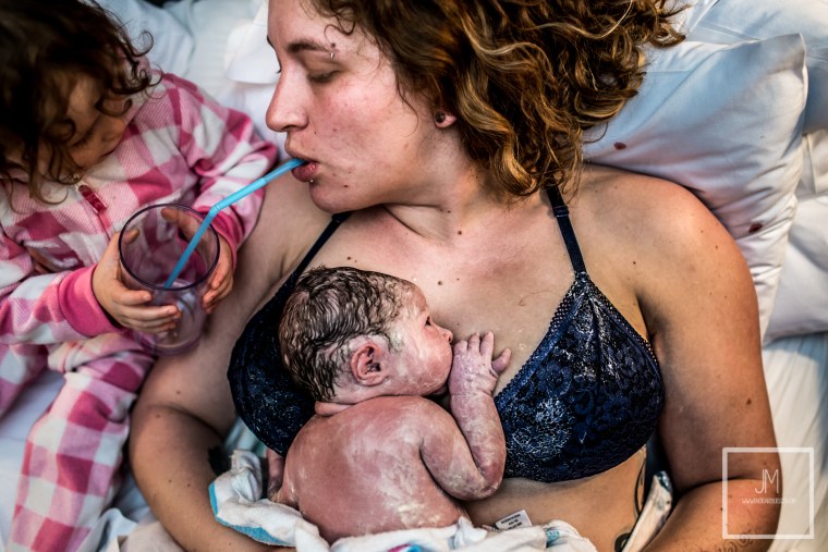 This moment between a mom and her toddler helping her drink following delivery won first place in the postpartum category of the 2019 Birth Becomes Her Image Contest.