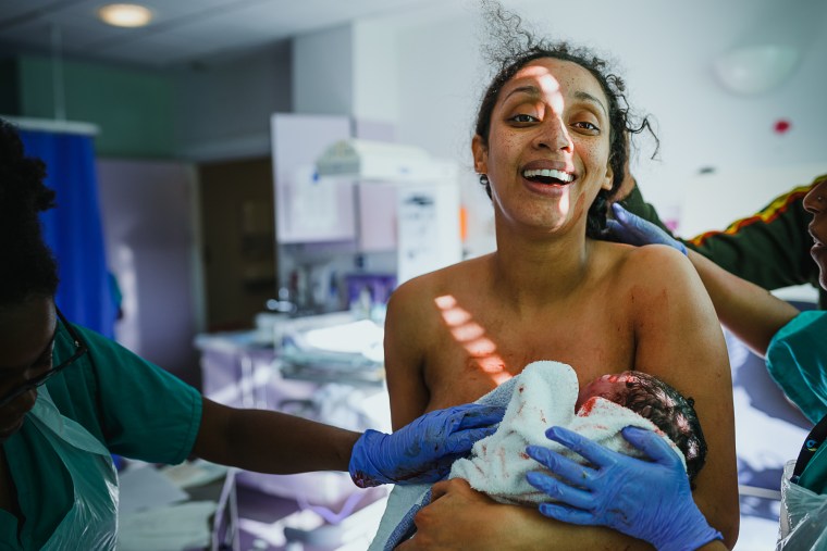 Sadie Wild's photograph of an exhausted mom cradling her baby after a hospital delivery won the 2019 Birth Becomes Her Image Contest for overall best image.