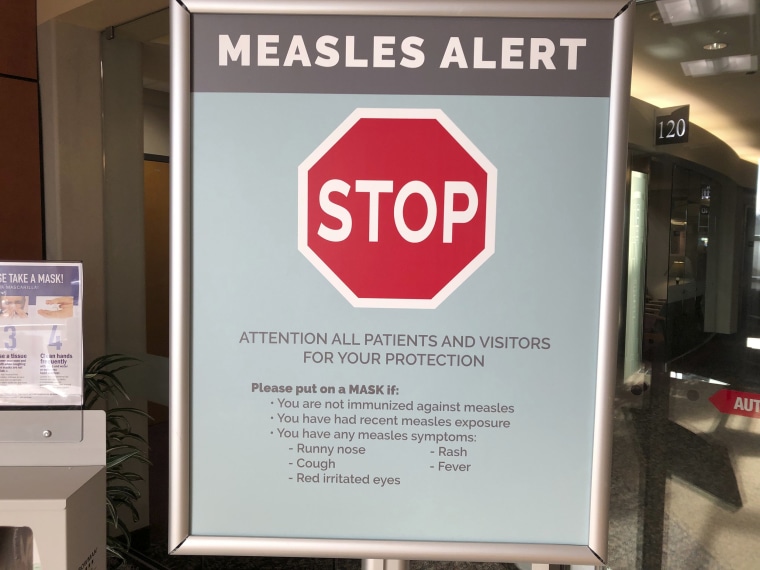 A sign posted at The Vancouver Clinic in Vancouver, Washington, warn patients and visitors of a measles outbreak