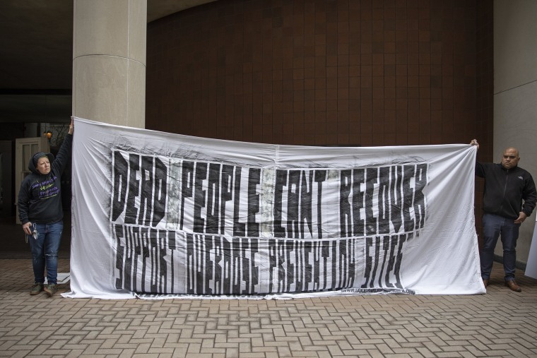 Image: Shey Hall, left, and Evan Figueroa-Vargas hold a banner in protest outside the U.S. Attorney's Office in Philadelphia on Feb. 6, 2019.