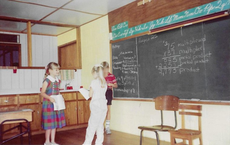 Jaasiel Mashek, in a plaid dress, stands inside the Aritao boarding school in the Philippines, August 1989.