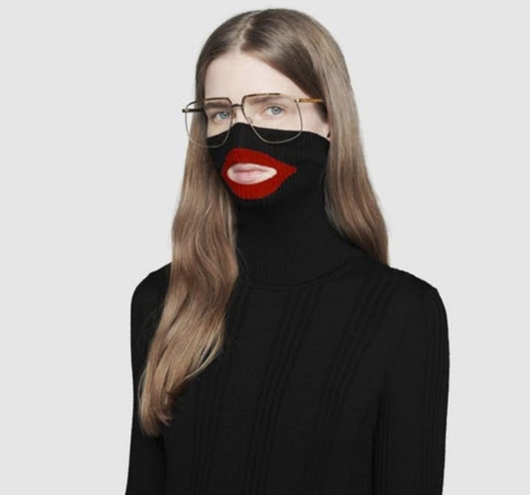 Image: An online fashion outlet showing a Gucci turtleneck black wool balaclava sweater for sale, that they recently pulled from its online and physical stores