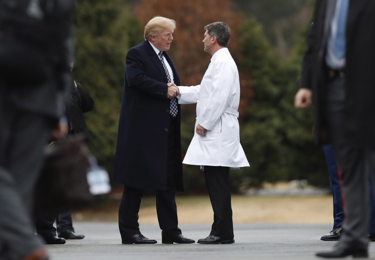 Image: President Donald Trump shakes hands with White House physician Dr. Ronny Jackson as he boards Marine One as he leaves Walter Reed National Military Medical Center in Bethesda