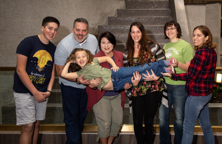 Ted, his wife Susan and their children Ethan and Olivia pose with Ted's biological children through sperm donorship, Melissa Daniels, Hannah Maitland and Alexandra Cheshire.