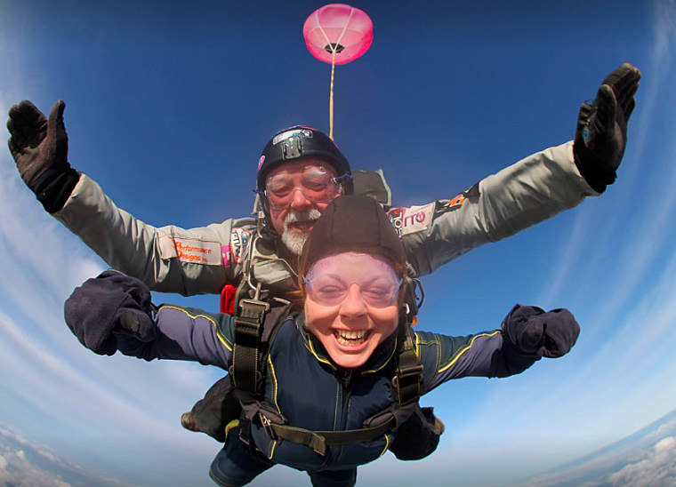 Marianne Power jumping out of an airplane.