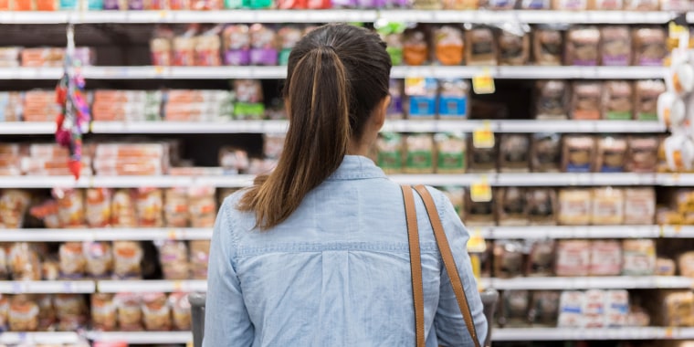 Woman marvels at grocery bread selection