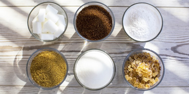 Glasses of sugar in various forms, overhead view