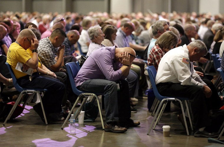 Image: People pray during the annual meeting of the Southern Baptist Convention on June 14, 2016, in St. Louis.