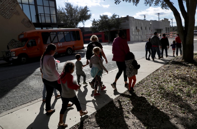 Image: Immigrants walk to an aid center after being released from government detention in McAllen, Texas, on Nov. 3, 2018.