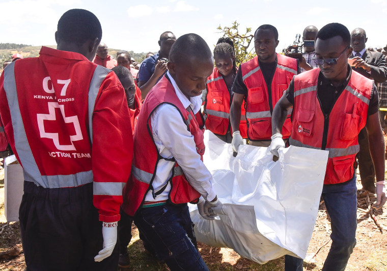 Members of the Kenya Red Cross carry victims' bodies after a Cessna 206 light aircraft crashed