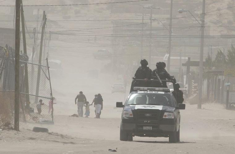 Image: Federal police patrol an impoverished neighbourhood in the border city of Ciudad Juarez
