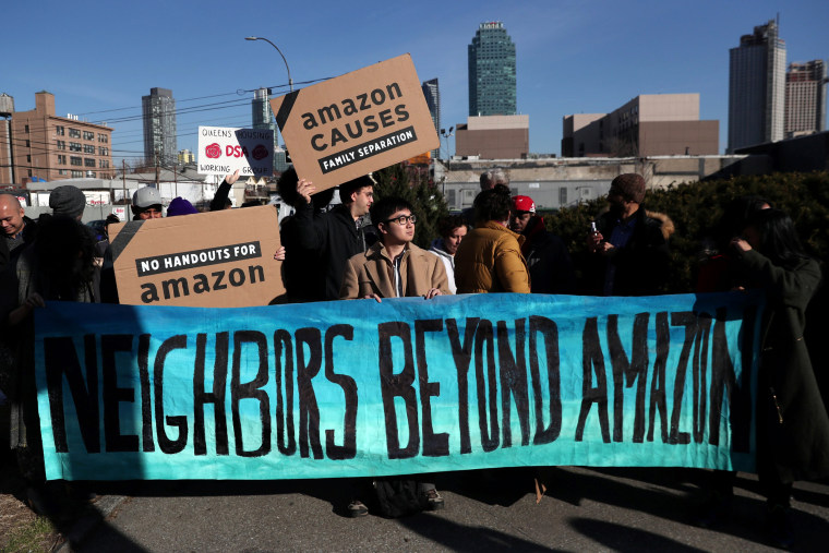 Image: Demonstrators hold signs during a protest against Amazon in Long Island City, Queens, on Feb. 14, 2019.