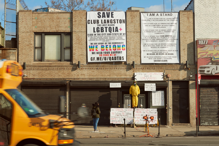 Calvin Clark stands in front of Club Langston in a silent protest in Brooklyn, New York.